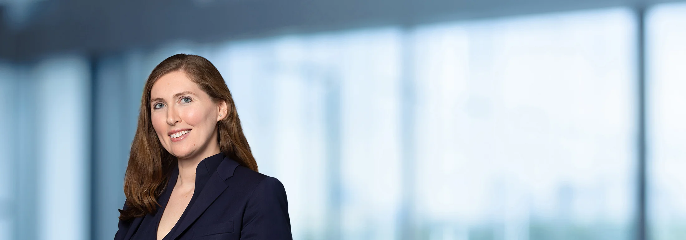 A photo of attorney, Sidorela Deliu-Kerasiotis, against a softly blurred office background