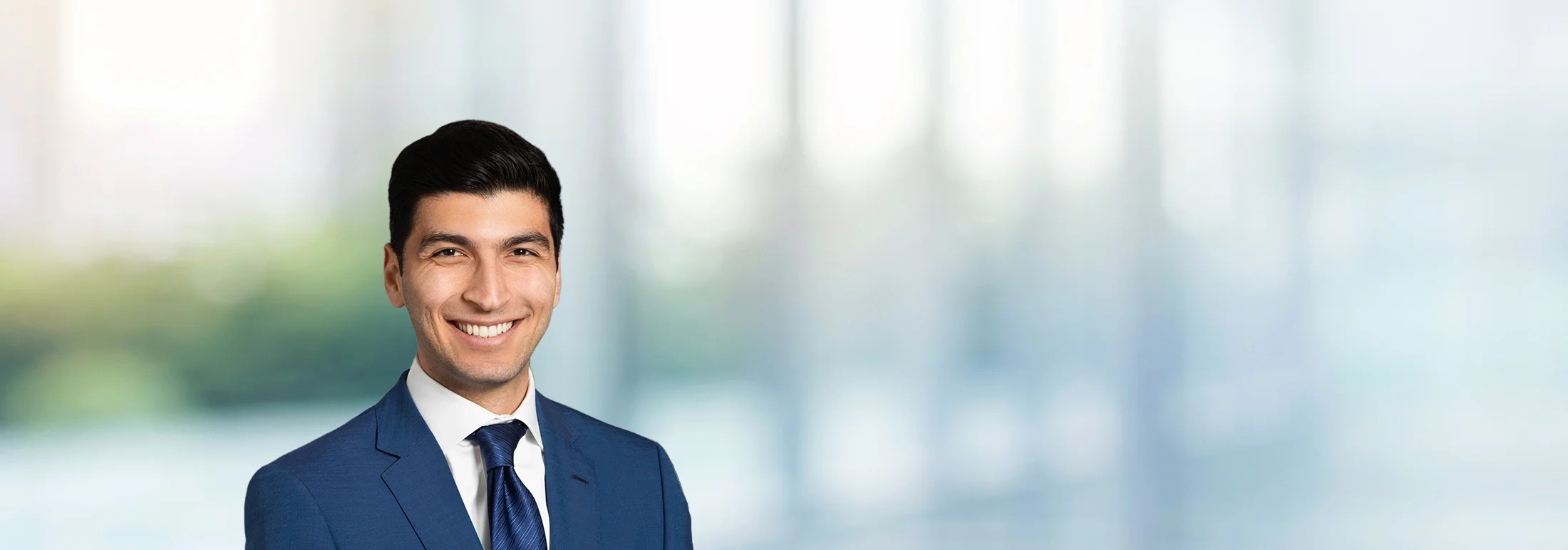 A photo of attorney, Arman Mashoof, against a softly blurred office background