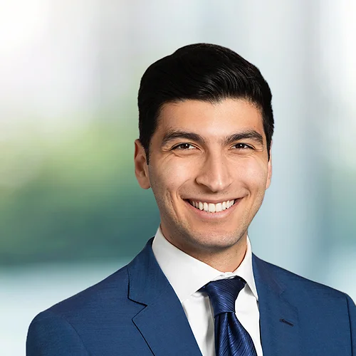 A photo of attorney, Arman Mashoof, against a softly blurred office background