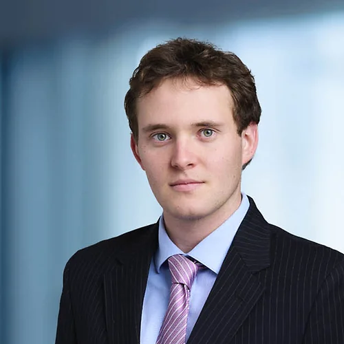 A photo of attorney, Renat Sigunov, against a softly blurred office background