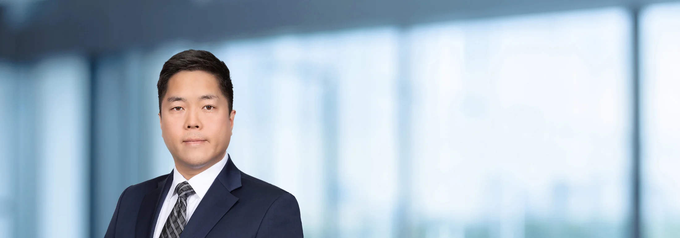 A photo of attorney, Marcus Lee, against a softly blurred office background.
