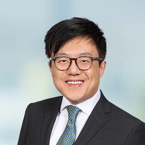 A photo of attorney, Inku Nam, against a softly blurred office background.