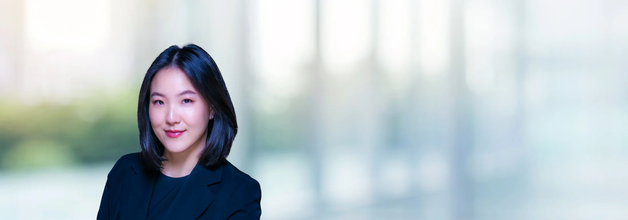 A photo of attorney, Remee Kim, against a softly blurred office background