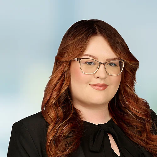 A photo of attorney, Tara McManamy, against a softly blurred office background.