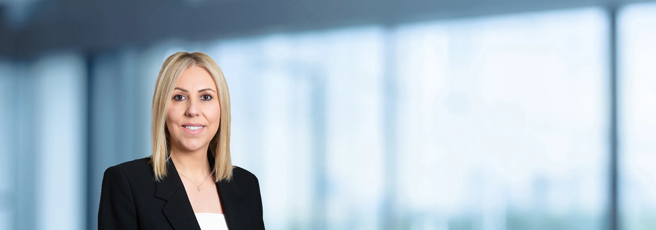 A photo of attorney, Vickie Grasu, against a softly blurred office background