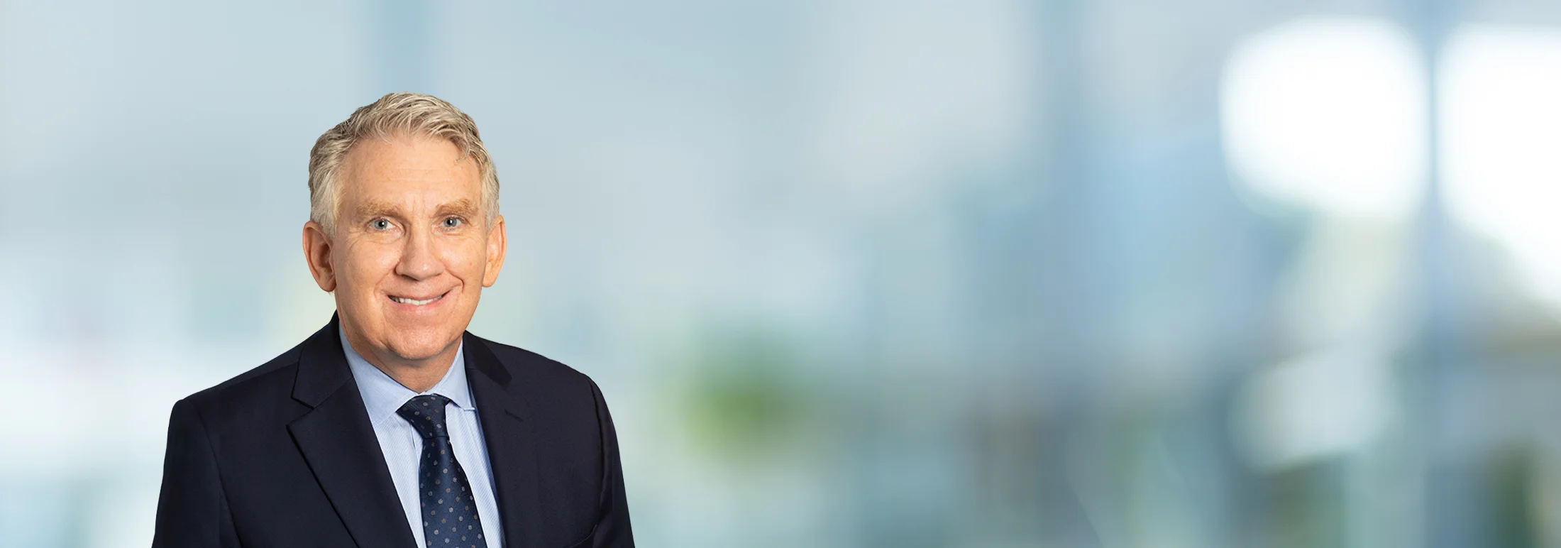 A photo of attorney, Clint Robison, against a softly blurred office background.