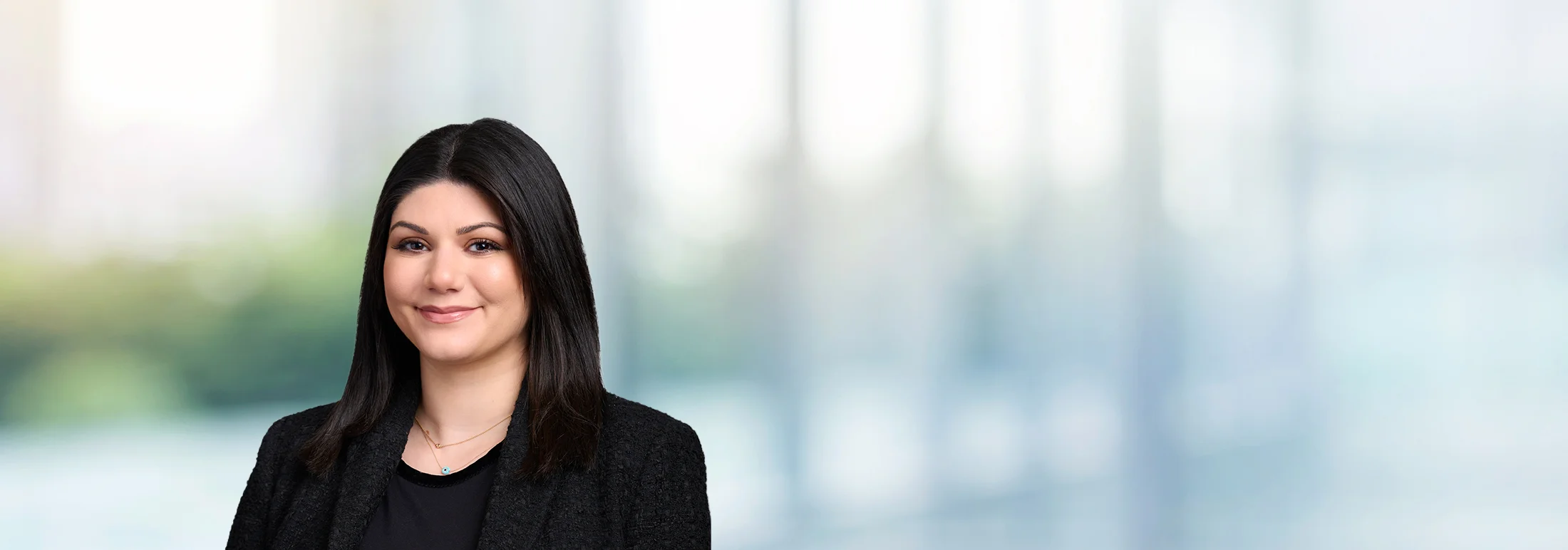 A photo of attorney, Kristen Mullis, against a softly blurred office background.