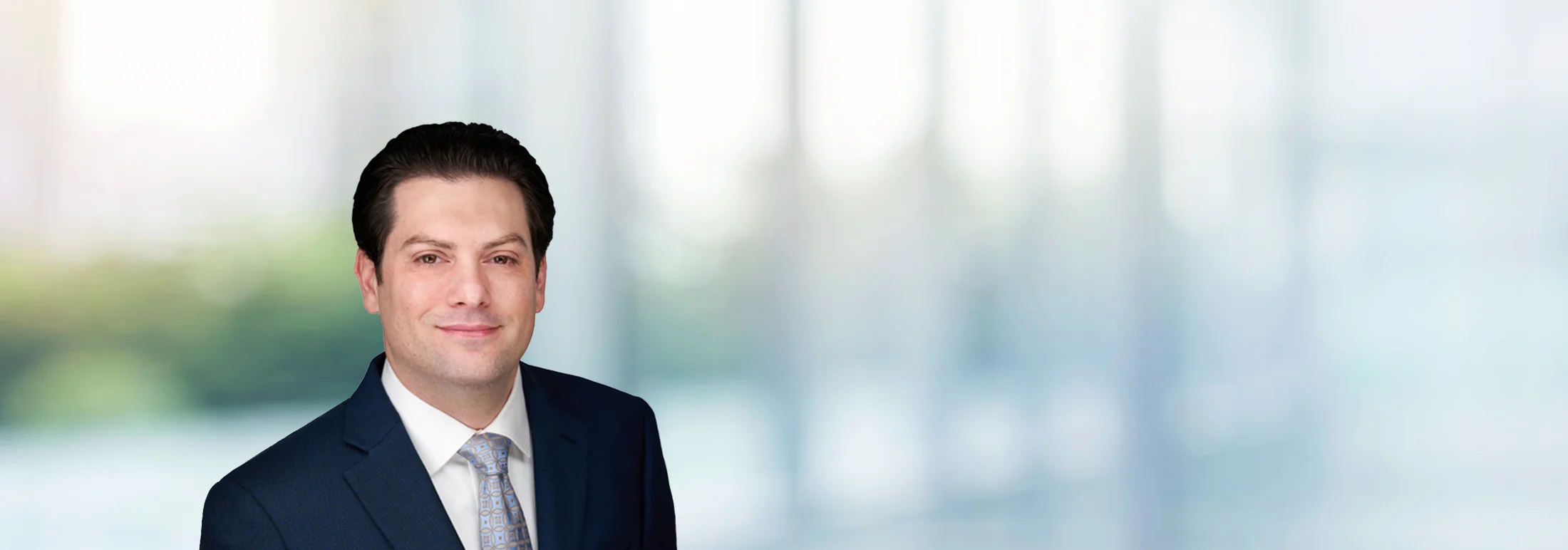 A photo of attorney Brad Bergman against a softly blurred office background