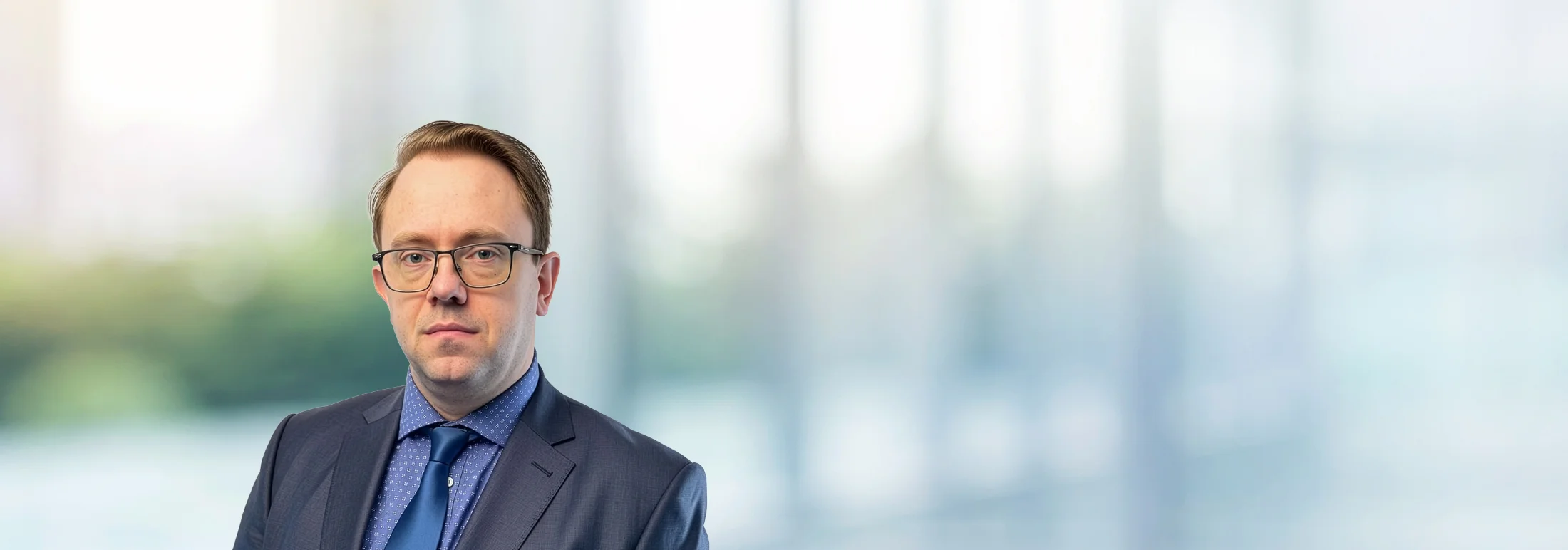 A photo of attorney Will Bohannon against a softly blurred office background