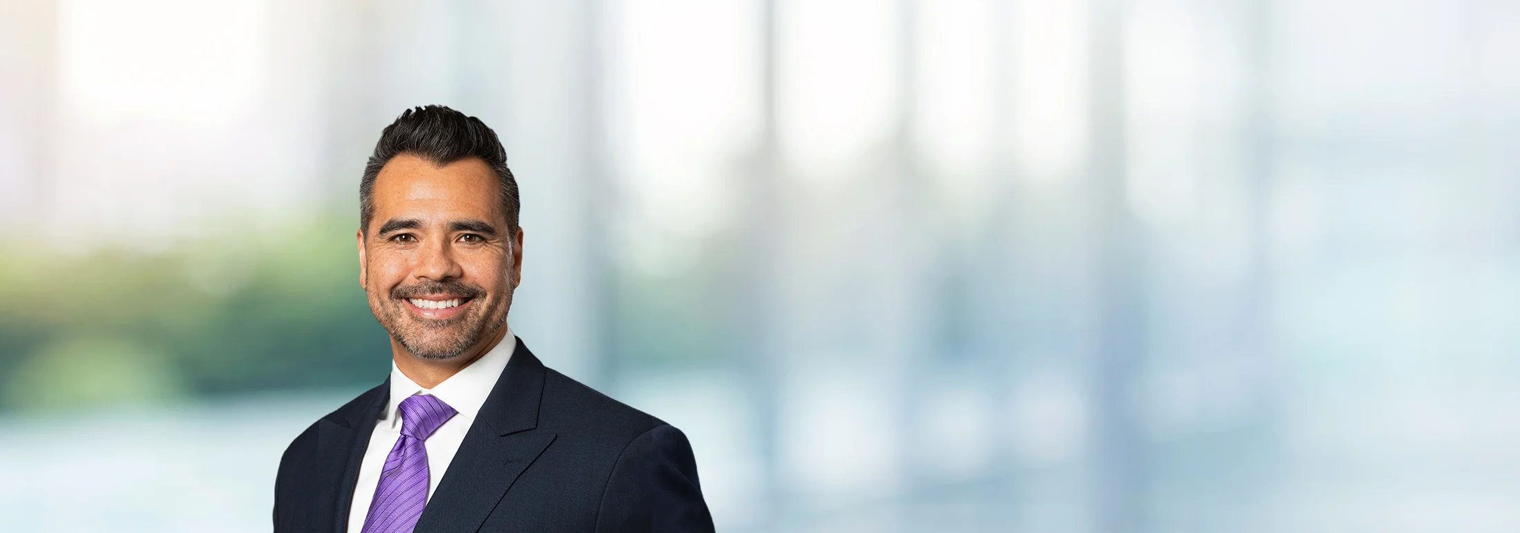 A photo of attorney Vincent Fisher against a softly blurred office background