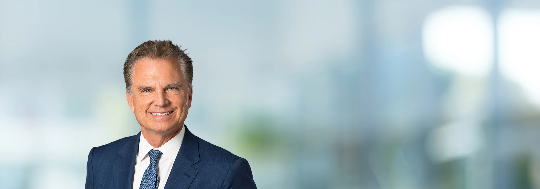 A photo of attorney, Maurice Fitzgerald, against a softly blurred office background