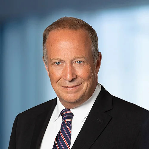 A photo of attorney, Emmett Gilman, against a softly blurred office background