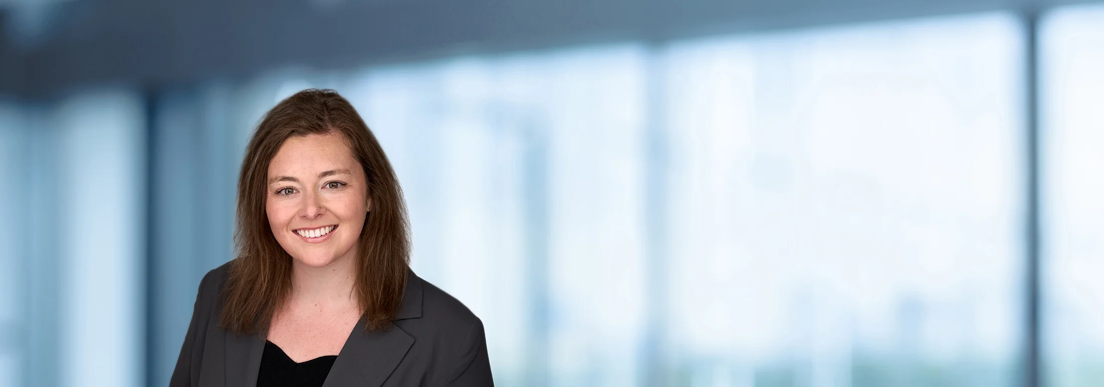A photo of attorney Annie Hatton against a softly blurred office background