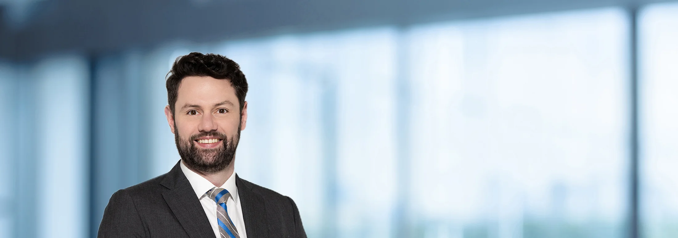 A photo of attorney, Geoff Hersch, against a softly blurred office background