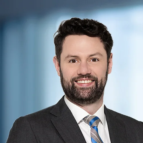 A photo of attorney, Geoff Hersch, against a softly blurred office background
