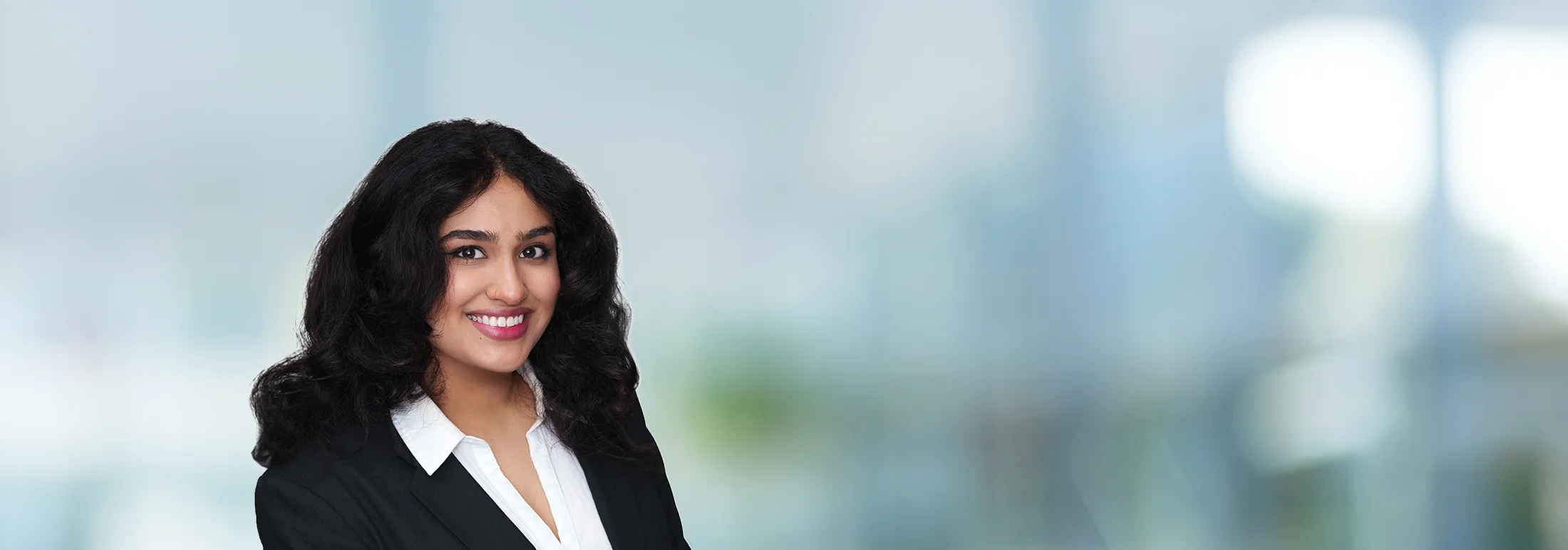 A photo of attorney Jannat Irshad against a softly blurred office background