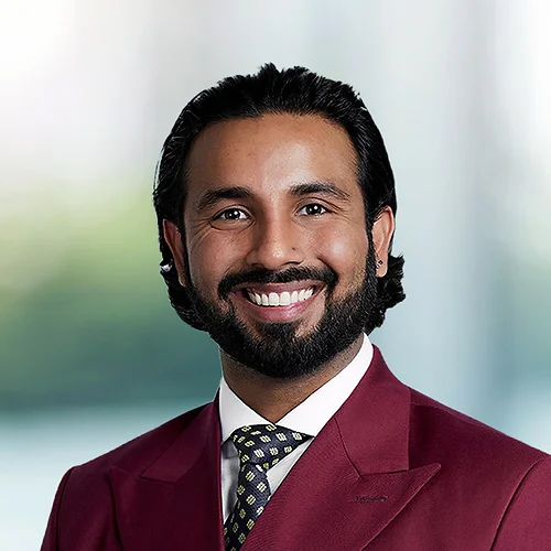 A photo of attorney Muhammad Aadil against a softly blurred office background