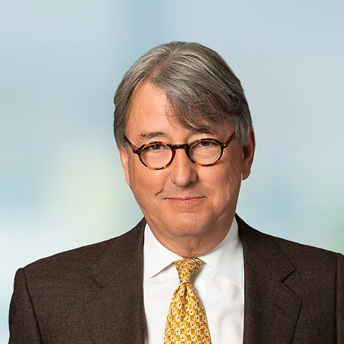 A photo of attorney, Daniel Qualls, against a softly blurred office background
