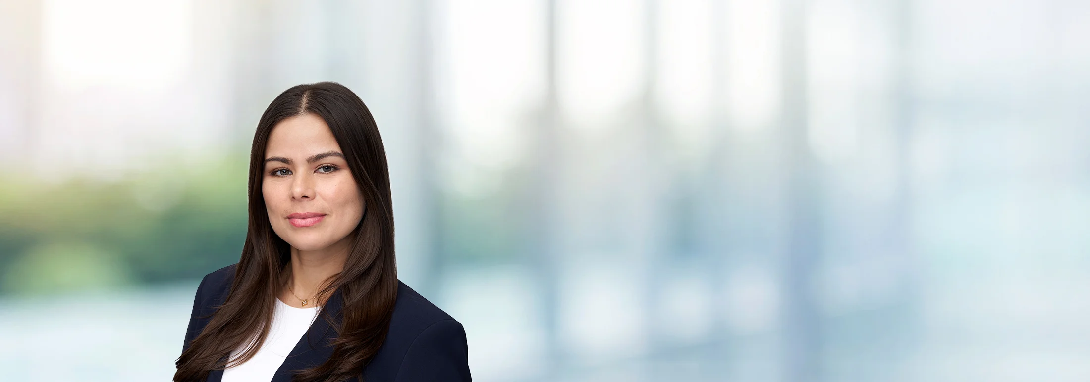 A photo of attorney Fatima Ramos against a softly blurred office background