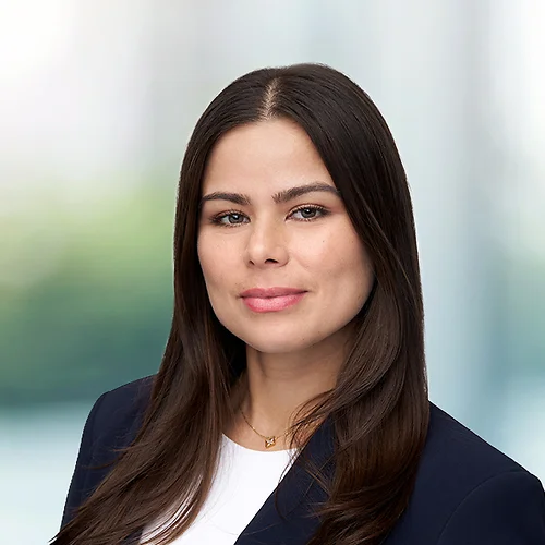 A photo of attorney Fatima Ramos against a softly blurred office background