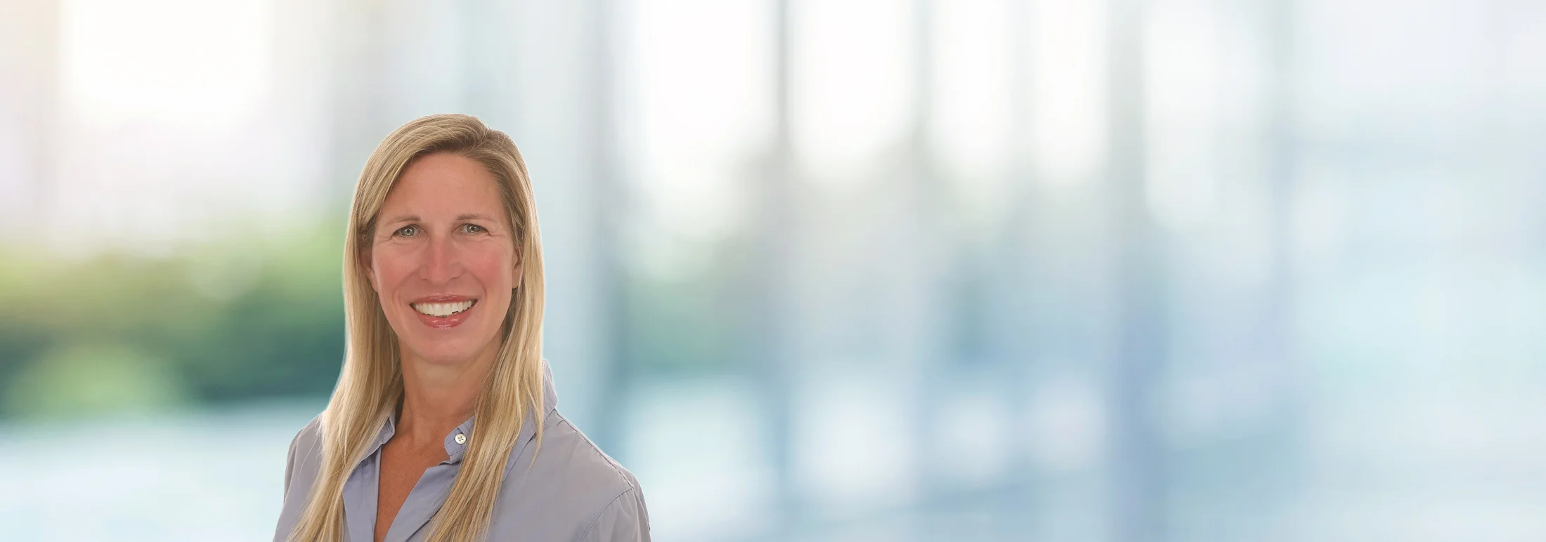 A photo of attorney, Erica Rocush, against a softly blurred office background