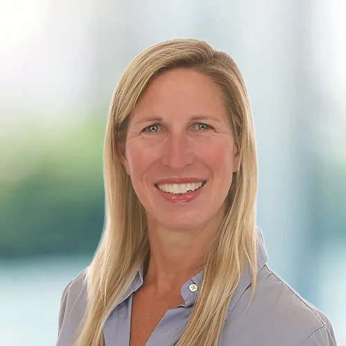 A photo of attorney, Erica Rocush, against a softly blurred office background