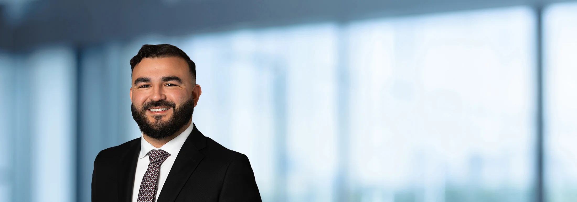A photo of attorney Cruz Zavala against a softly blurred office background
