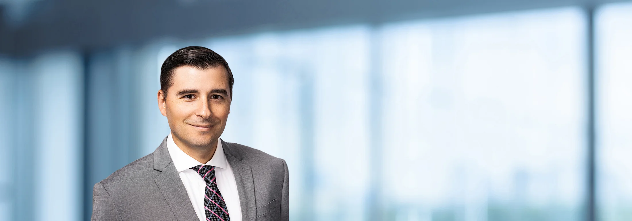 A photo of attorney, Anthony Oceguera, against a softly blurred office background
