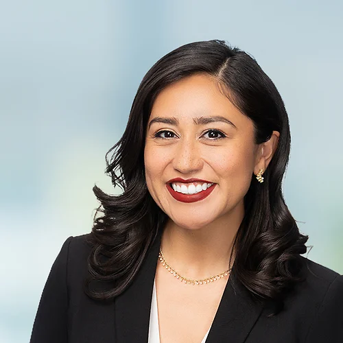 A photo of attorney Adriana Rodriguez against a softly blurred office background