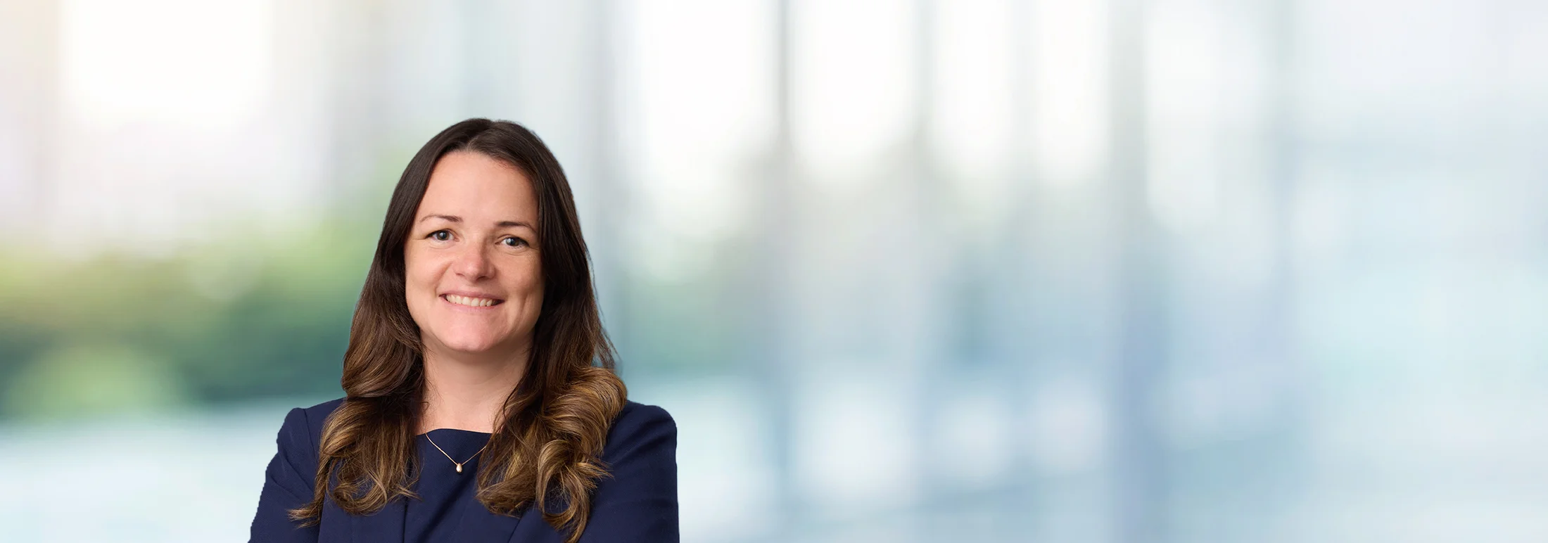 A photo of attorney Nicolet Corliss against a softly blurred office background