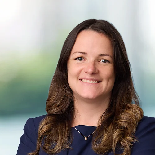 A photo of attorney Nicolet Corliss against a softly blurred office background