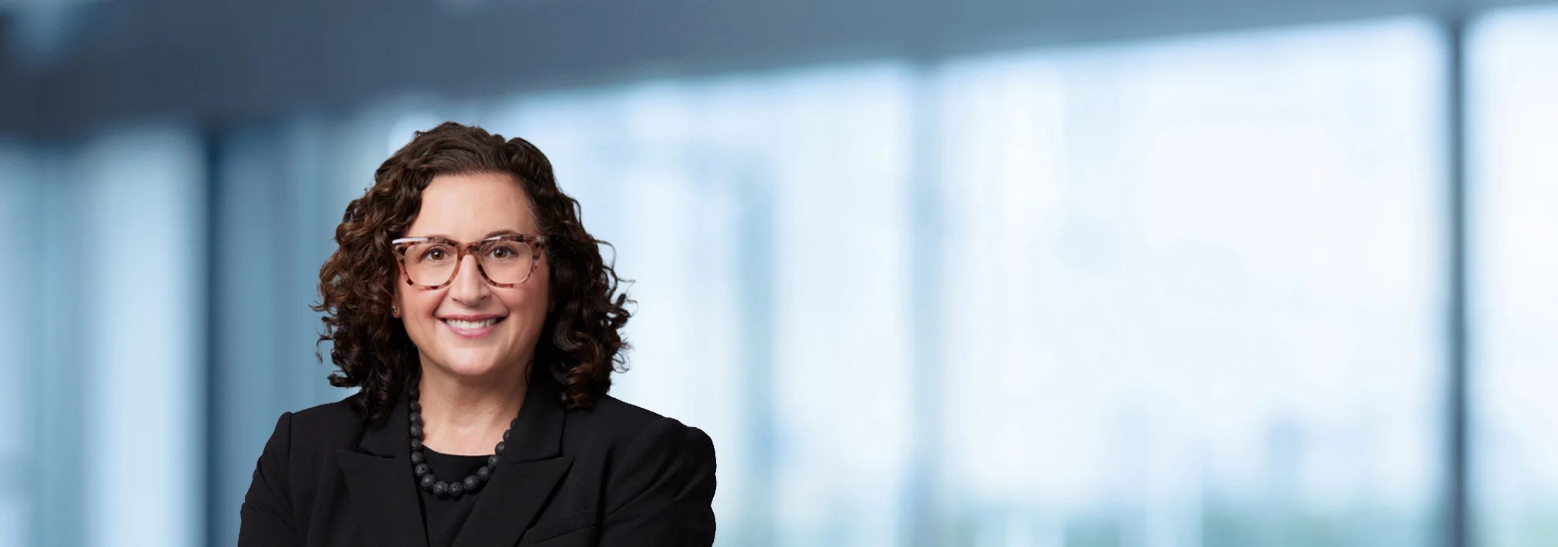 A photo of attorney, Naomi Johnson, against a softly blurred office background