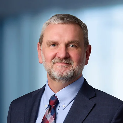 A photo of attorney, John Kreutzer, against a softly blurred office background