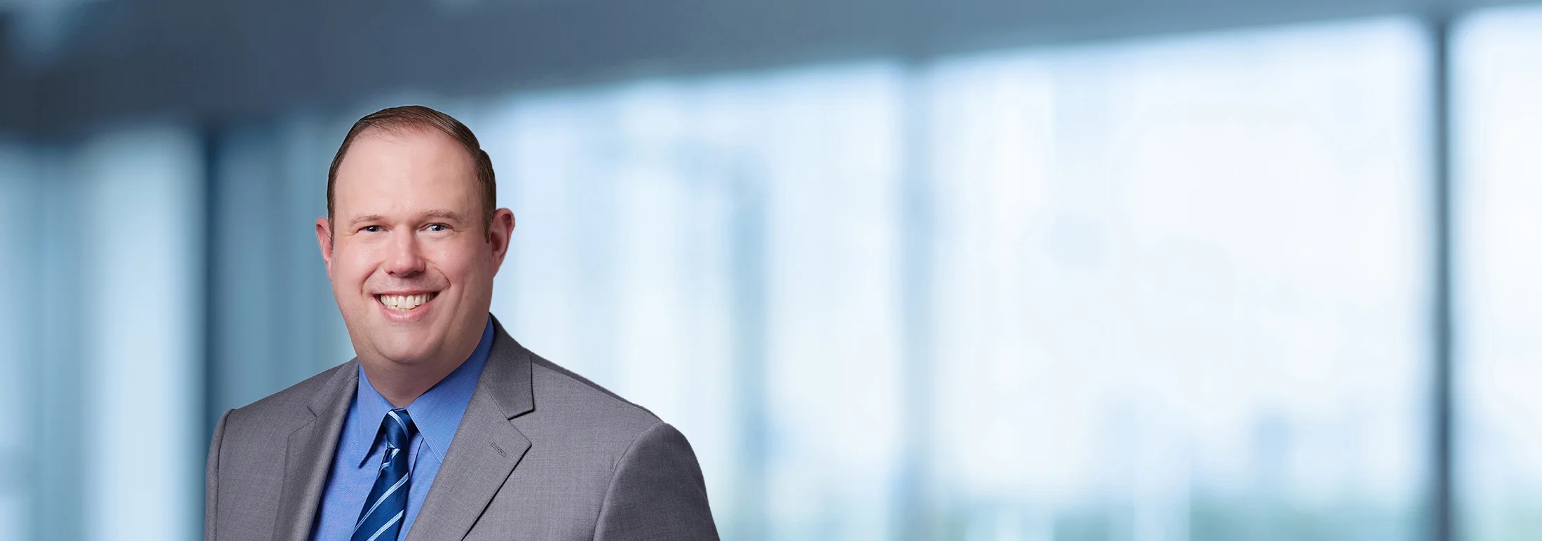 A photo of attorney, Brad Krupicka, against a softly blurred office background