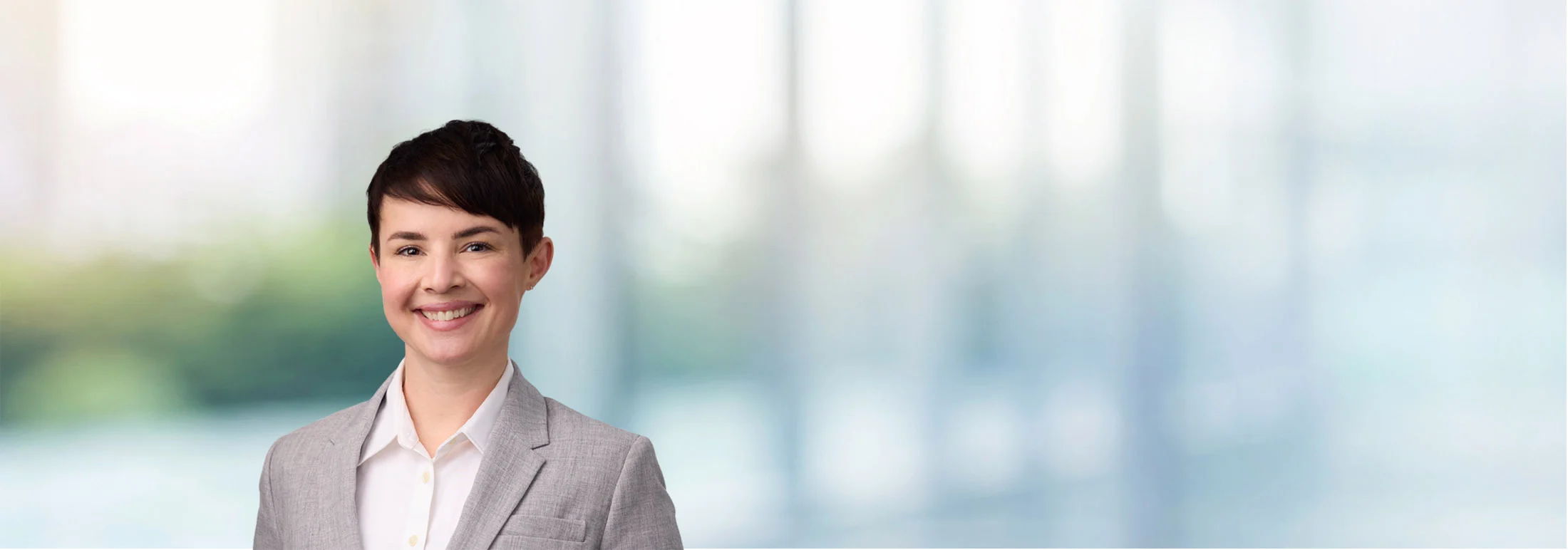 A photo of attorney Jenna Minard against a softly blurred office background