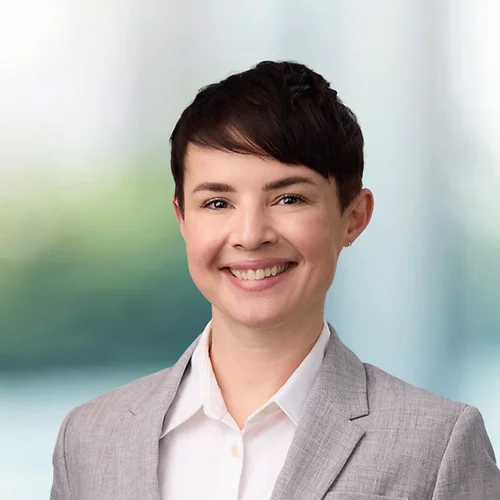 A photo of attorney Jenna Minard against a softly blurred office background