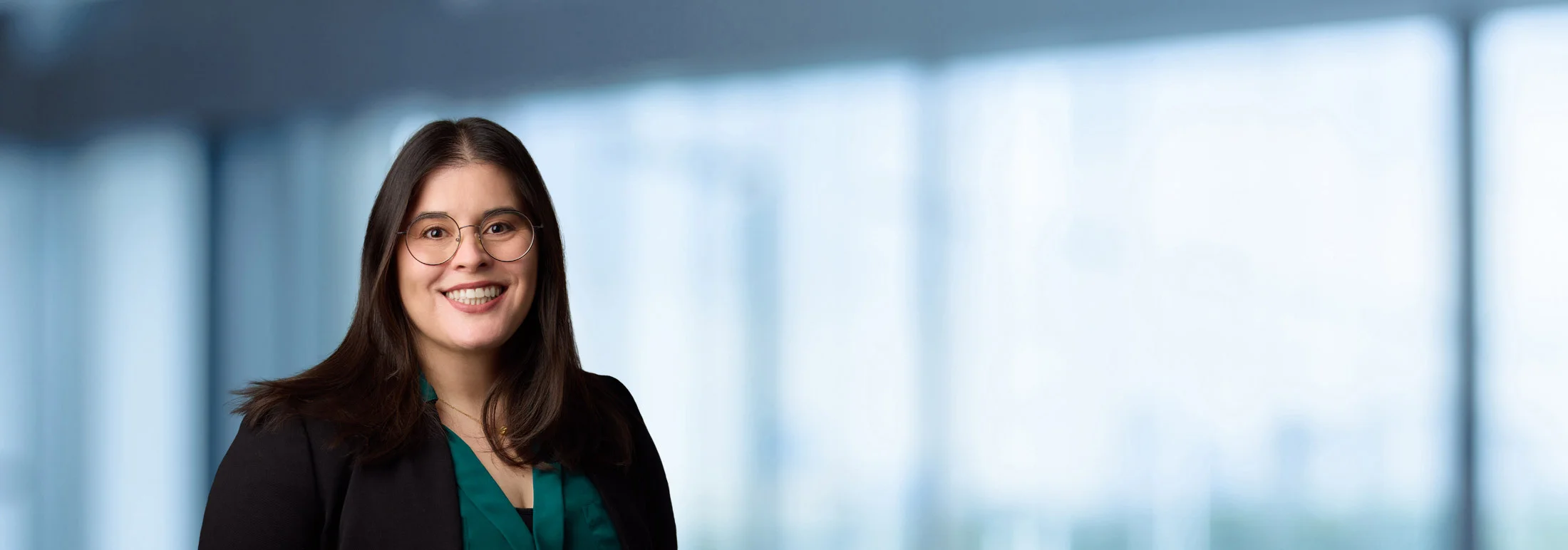 A photo of attorney Tara Mokhtarzadeh against a softly blurred office background