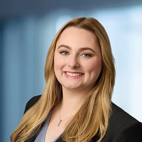 A photo of attorney Grace Zusman against a softly blurred office background