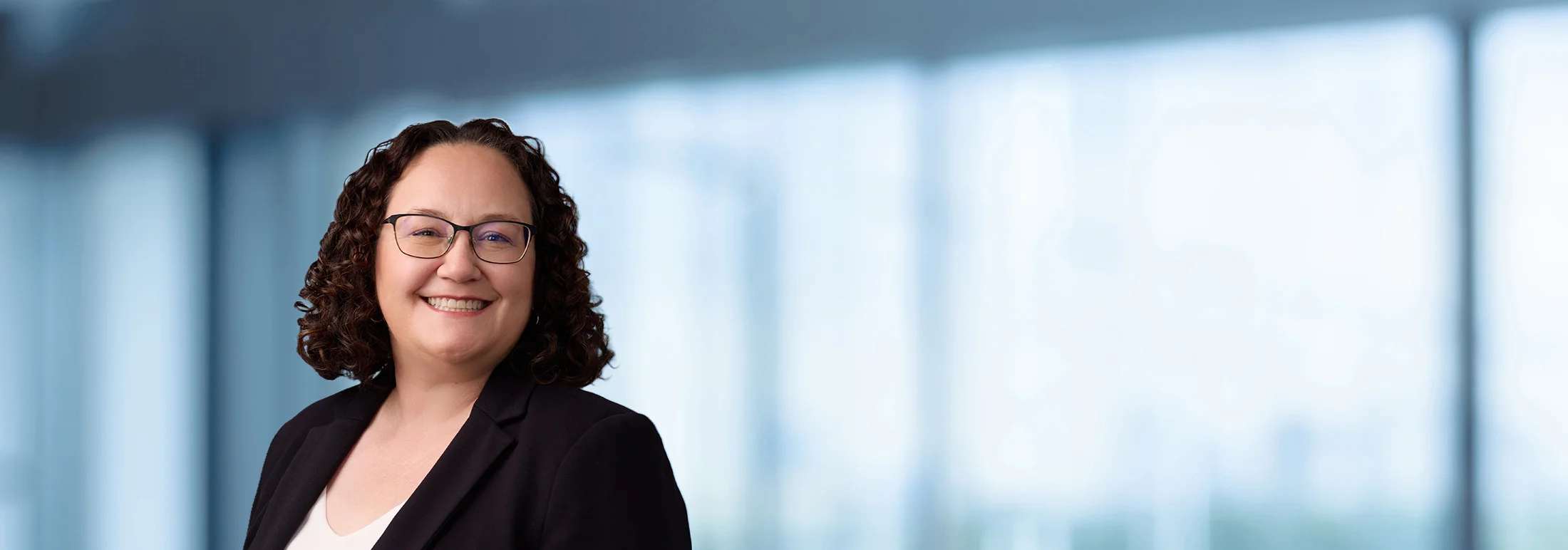 A photo of attorney Melissa LeBlanc-Mansell against a softly blurred office background