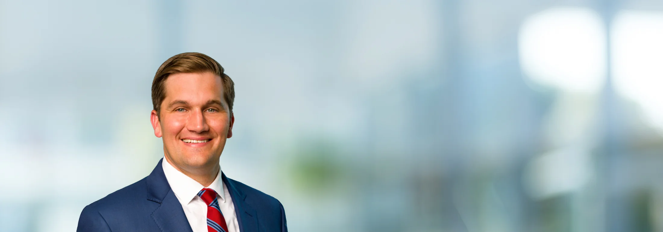 A photo of attorney Quinn Adams against a softly blurred office background