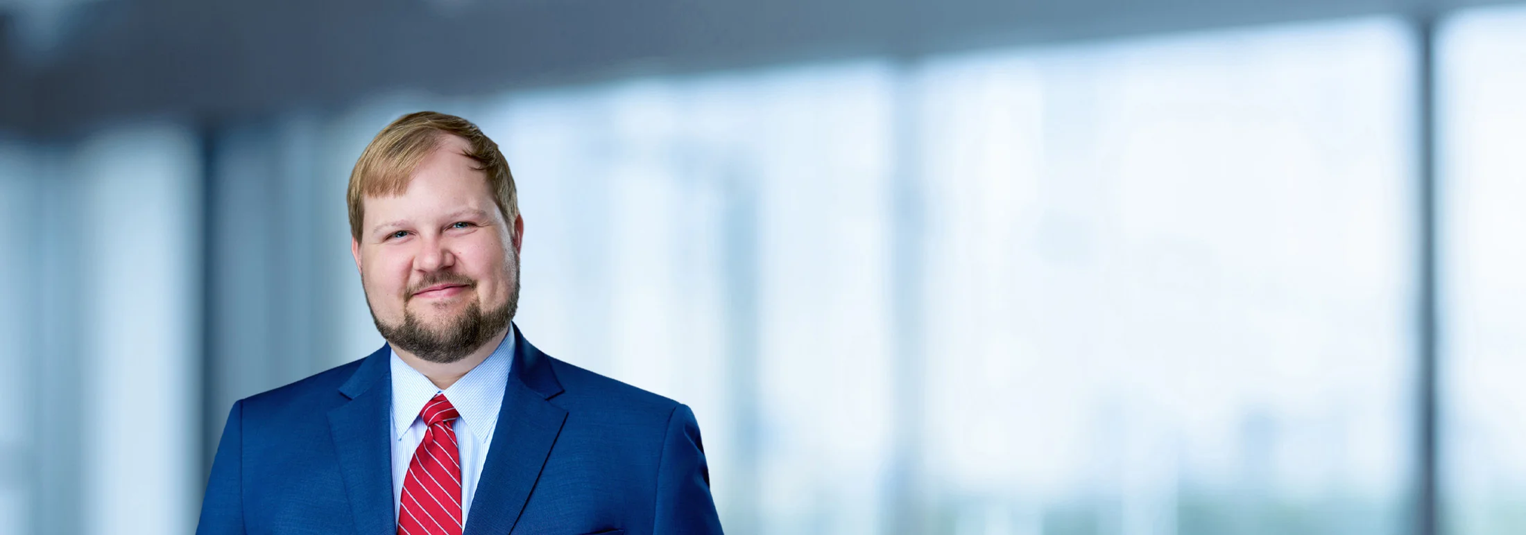 A photo of attorney Brooks Cain against a softly blurred office background