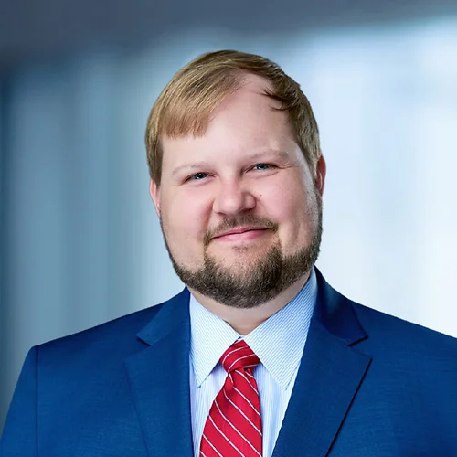 A photo of attorney Brooks Cain against a softly blurred office background