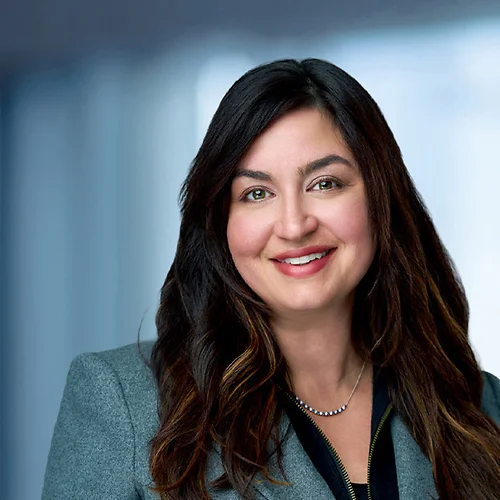 A photo of attorney, Rachael Loughlin, against a softly blurred office background