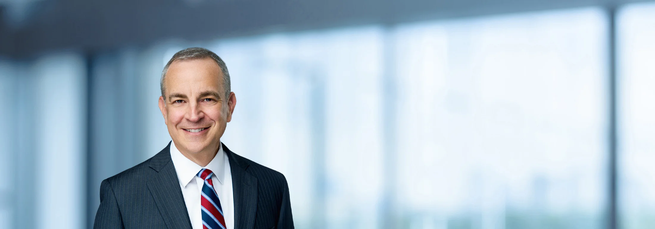 A photo of attorney, Mike Melis, against a softly blurred office background