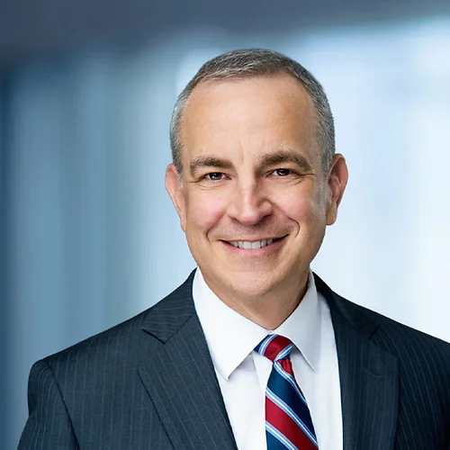 A photo of attorney, Mike Melis, against a softly blurred office background
