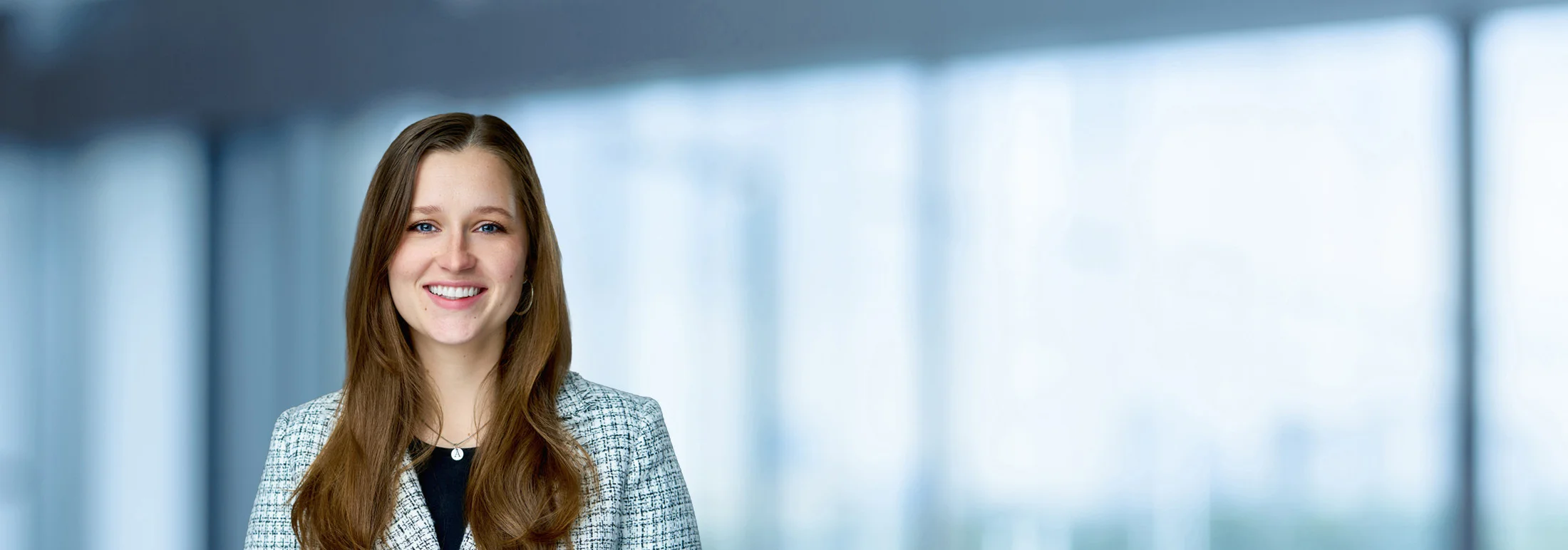 A photo of attorney Ashley Nelson against a softly blurred office background