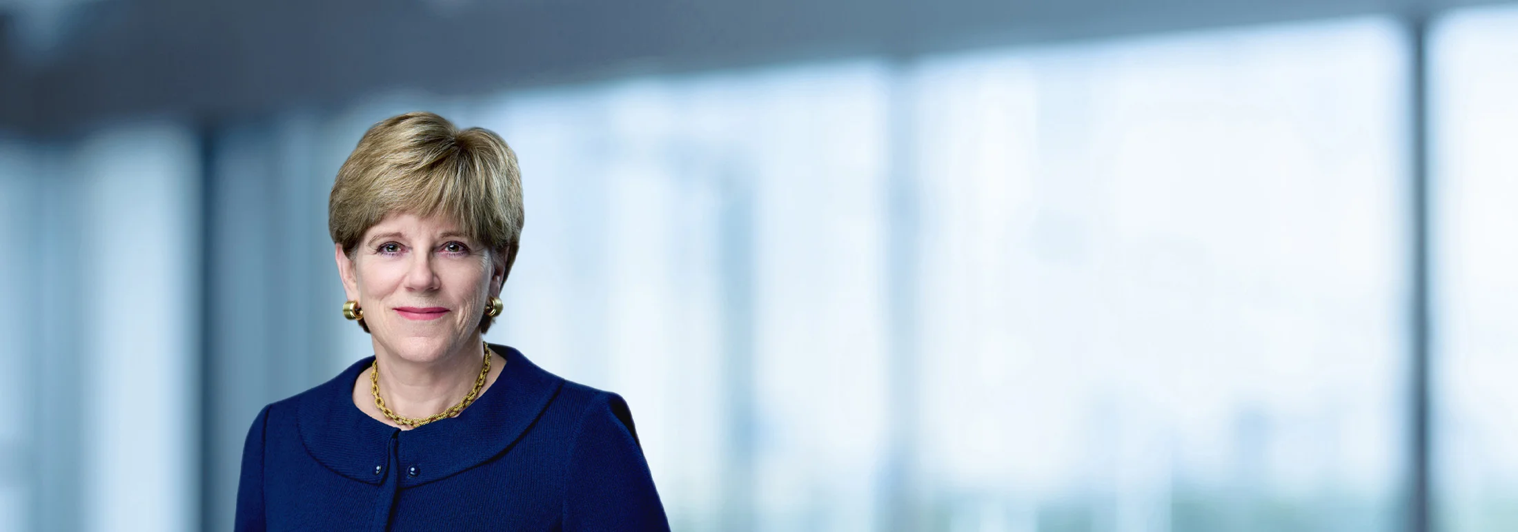 A photo of attorney Ann Reardon against a softly blurred office background