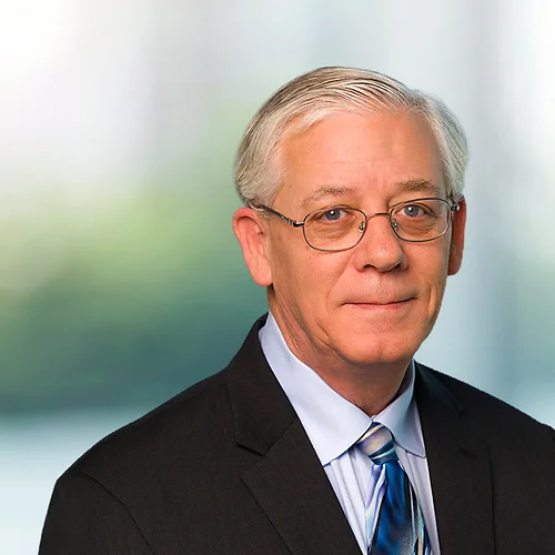 A photo of attorney, Jim Walker, against a softly blurred office background
