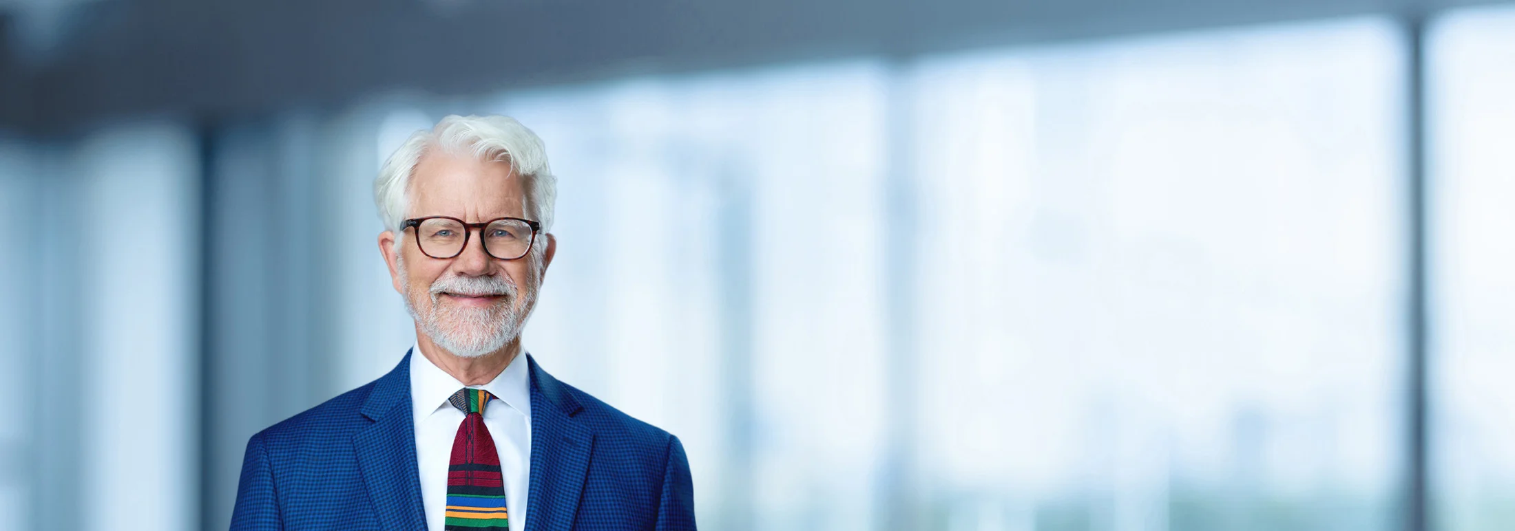 A photo of attorney Thomas Wolf against a softly blurred office background