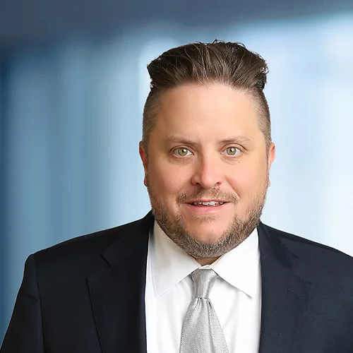 A photo of attorney John Brubaker against a softly blurred office background